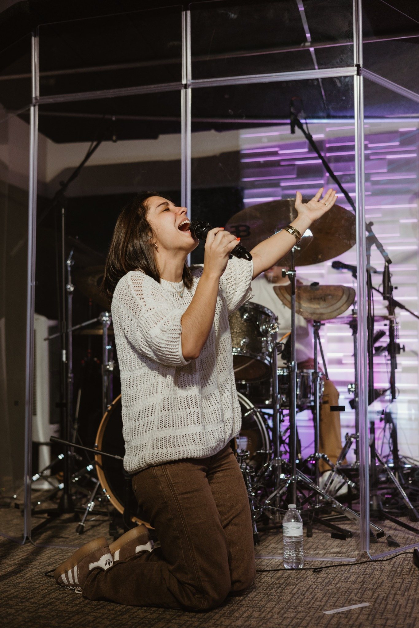 Worship vocalist kneeling in prayer